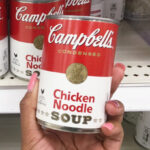 A Person Holding a Can of Campbells Condensed Chicken Noodle Soup