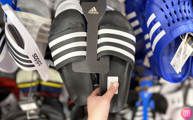 A Person Holding a Pair of Adidas Mens Adilette Aqua Slides