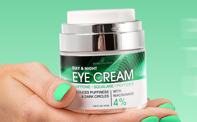 A Person Holding the Remedial Pax Eye Cream for Dark Circles and Puffiness