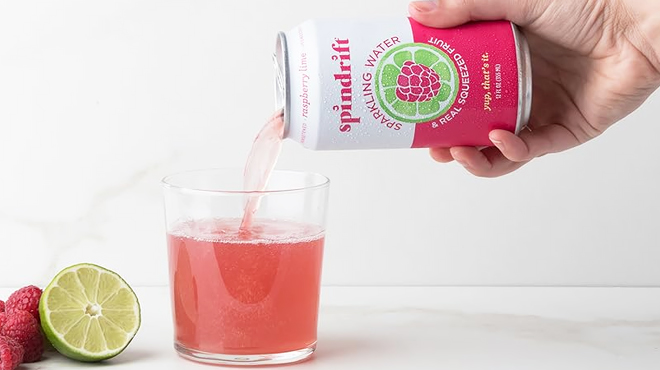 A Person Pouring Spindrift Sparkling Water to a Glass