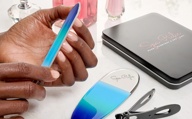 A Person Trimming Nails Using Nail File Clipper Set