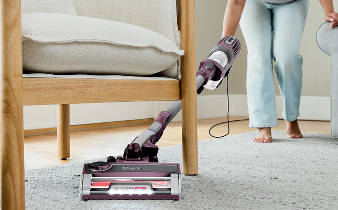 A Person Using a Shark UltraLight PowerFins HairPro Corded Vacuum