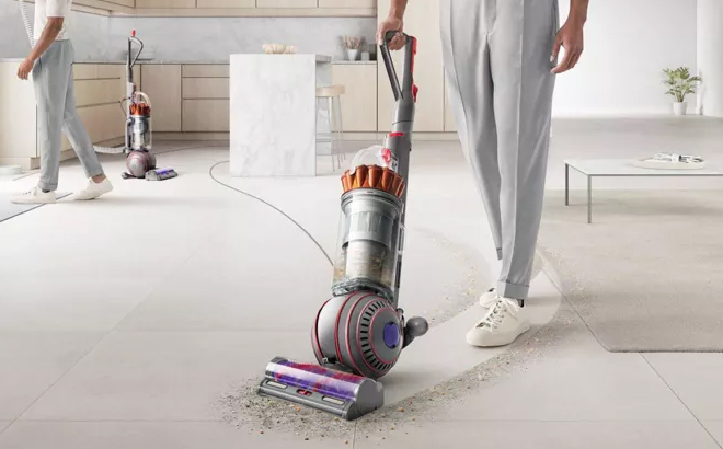 A Person Using the Dyson Ball Animal 3 Upright Vacuum in the House