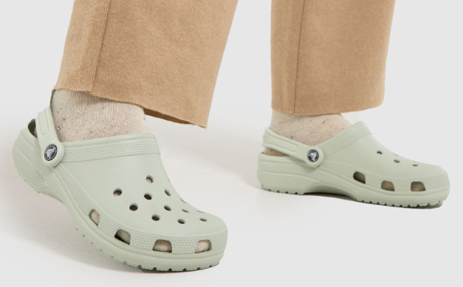 A Person Wearing Crocs Classic Clogs in Plaster Colorway