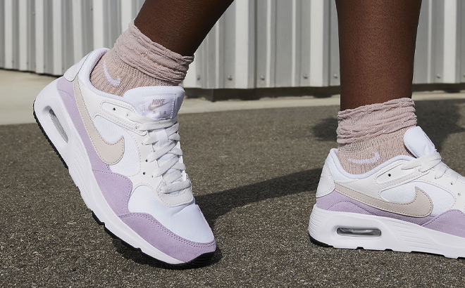 A Person Wearing Nike Air Max SC Womens Shoes