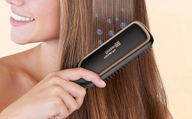 A Person brushing their Hair with Hair Straightener Brush