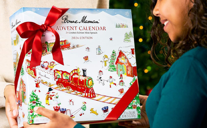 A Person holding a Bonne Maman 2024 Advent Calendar