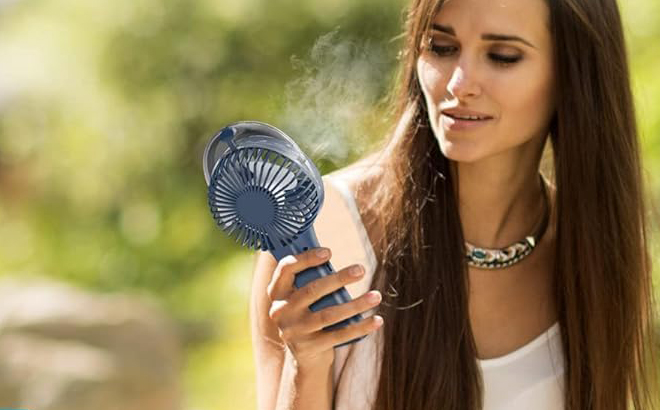 A Person holding a Handheld Misting Fan