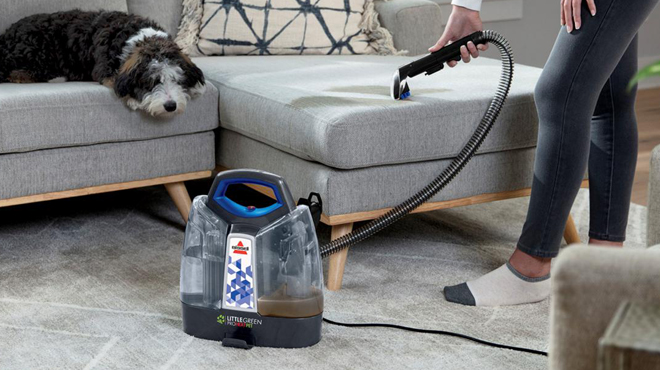 A Person using Bissell Little Green ProHeat Portable Deep Cleaner