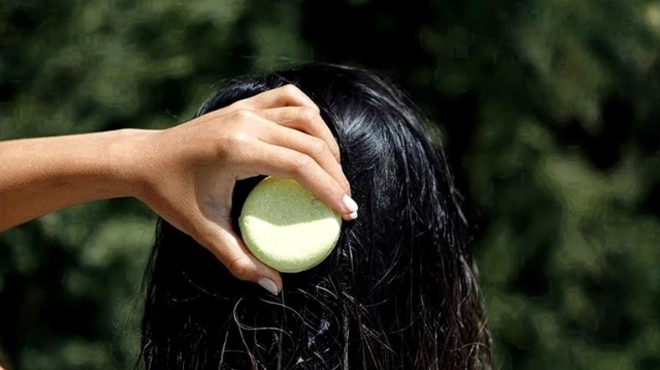 A Person using a Muun Rice Water Shampoo Bars