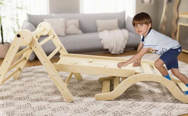 A Toddler Climbing on Pikler Triangle Set Climber