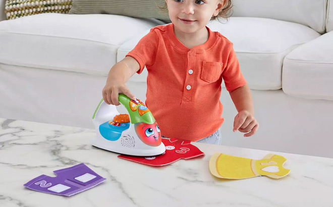 A Toddler Playing with Leapfrog Ironing Time Learning Set