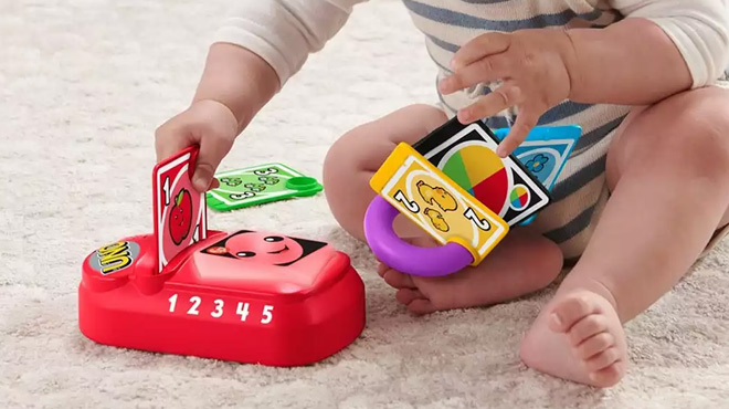 A Toddler Playing with the Fisher Price Counting and Colors UNO Game