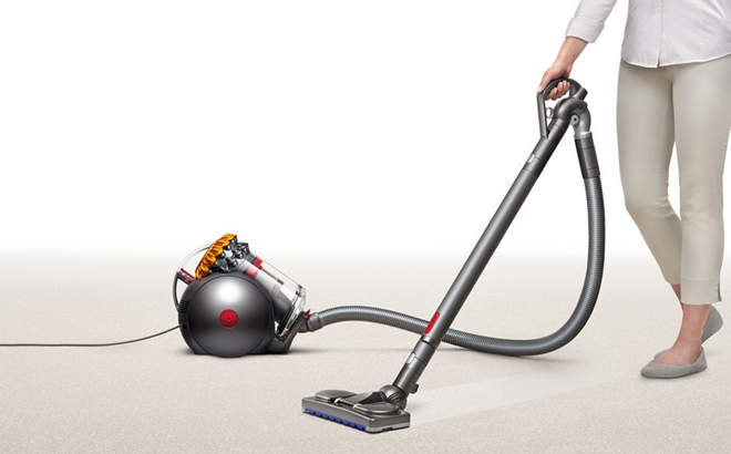 A Woman Cleaning with the Dyson Big Ball Turbinehead Canister Vacuum