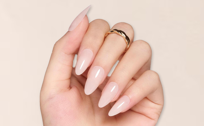 A Woman Having Beetles Gel Almond Shaped Press On Nails in Nude Pink