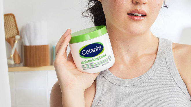 A Woman Holding Cetaphil Body Moisturizer