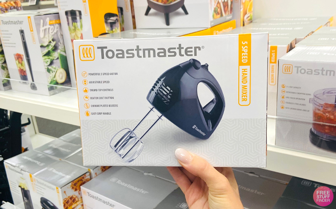 A Woman Holding Toastmaster Hand Mixer