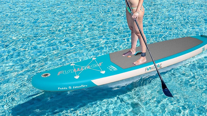 A Woman Standing on the FunWater Inflatable Ultra Light Stand Up Paddle Board