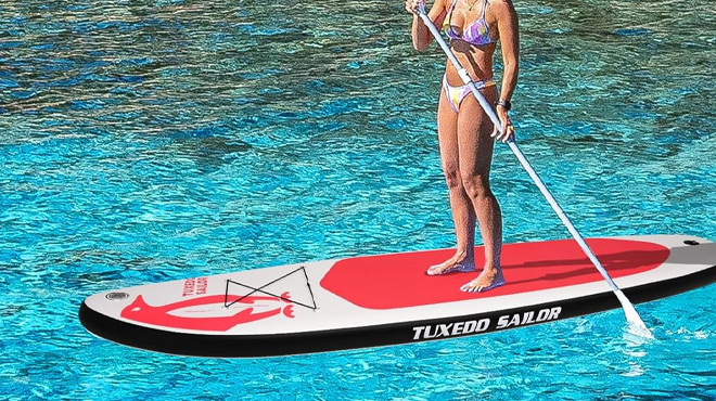 A Woman Standing on the Tuxedo Sailor Inflatable Stand Up Paddle Board