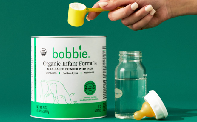 A Woman Taking a Scoop of Bobbie Organic Infant Formula