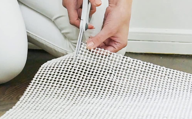 A Woman Trimming the Gorilla Grip Extra Strong Rug Pad Gripper