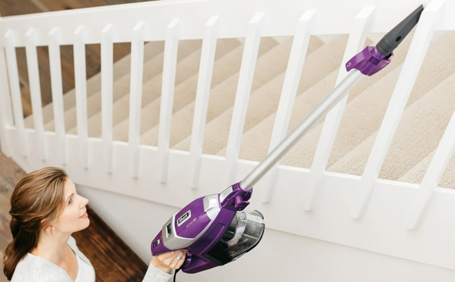 A Woman Using Shark Rocket Pet Pro Corded Stick Vacuum