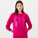 A Woman Wearing GAP Factory Logo Sweatshirt in Bright Beet Color