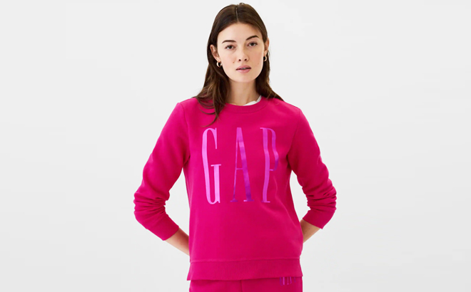 A Woman Wearing GAP Factory Logo Sweatshirt in Bright Beet Color