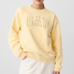 A Woman Wearing GAP Factory Logo Sweatshirt in Maize