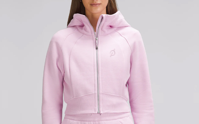 A Woman Wearing Lululemon x Peloton Scuba Full Zip Cropped Hoodie