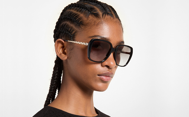 A Woman Wearing Michael Kors Albany Sunglasses in Black