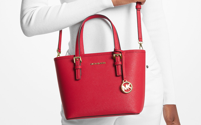 A Woman Wearing Michael Kors Jet Set Travel Extra Small Saffiano Leather Top Zip Tote Bag