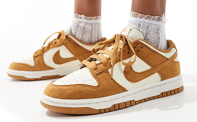 A Woman Wearing Nike Dunk Low Shoes in Ivory