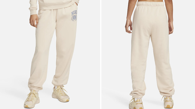 A Woman Wearing Nike Sportswear Club Fleece Oversized Mid Rise Sweatpants in Sanddrift