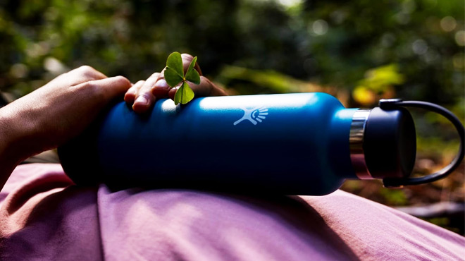 A person holding a Hydro Flask Stainless Steel Standard Mouth Bottle 18 oz in Indigo Color