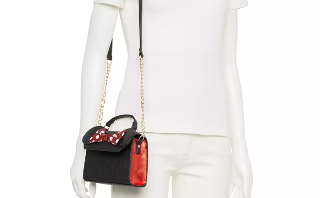 Disneys Minnie Mouse Ears Bow Crossbody Bag on a Mannequin