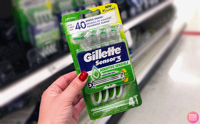 Hand holding Gillette Sensor3 Disposable Razor 4 Count