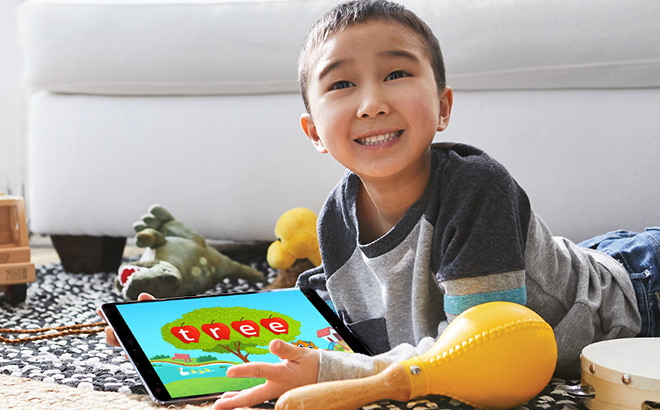 Kid Laying on the Floor Holding a Tablet