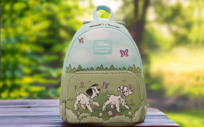 Loungefly Disney 101 Dalmatians Flower Field Mini Backpack on a Bench