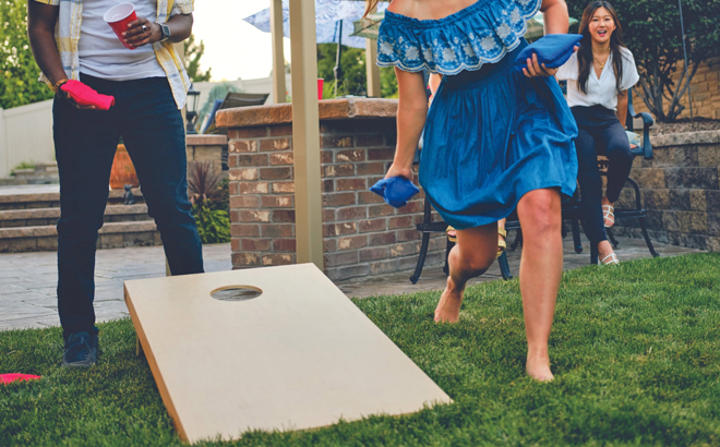 People Playing Cornhole with a Wooden Cornhole Set