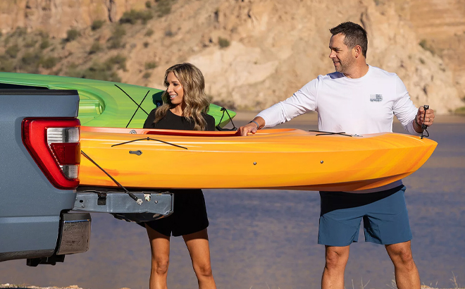 People Putting the Quest Canyon 100 Kayak in the Back of a Truck