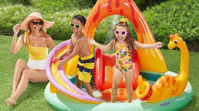 People playing in Funsicle 6 Ft Volcanic Valley Inflatable Playcenter with Kids Slide