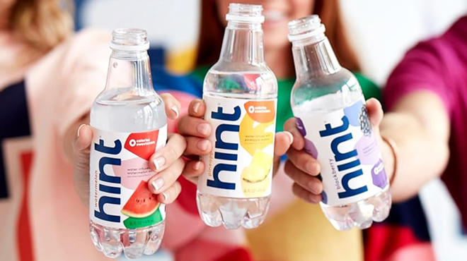 Three People Holding Bottles of Hint Water