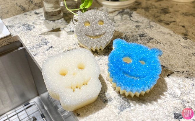 Three Scrub Mommy Harvest Sponges on a Kitchen Countertop