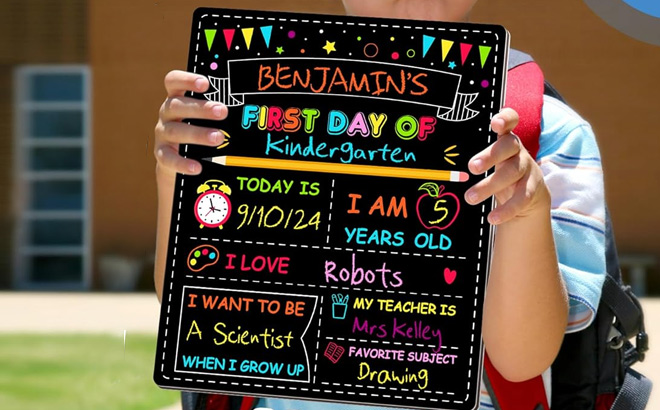 a Kid Holding First Day of School Chalkboard