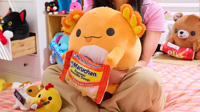 Kid Holding Snackles Maruchan Axolotl Unicorn Super Sized 14 inch Plush