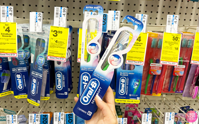 a Person Holding Two Oral B Tothbrushes