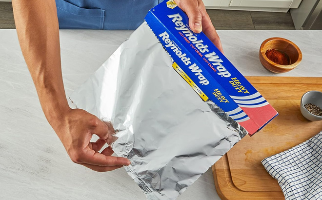 a Person Opening Reynolds Wrap Heavy Duty Aluminum Foil