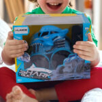 A Boy Holding the Vilinice Remote Control Shark Monster Truck Toy