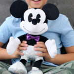 A Child Holding a Mickey Mouse Large Plush